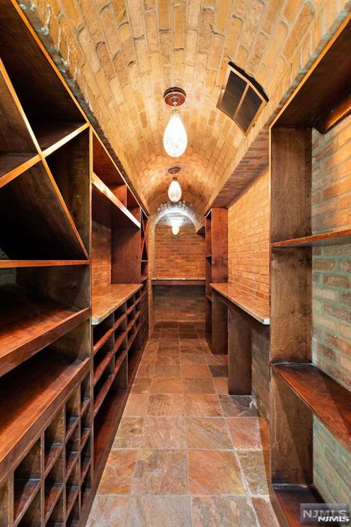 wine room featuring brick wall and brick ceiling