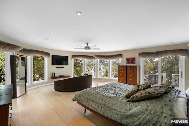 bedroom with light wood-type flooring, ceiling fan, and access to exterior