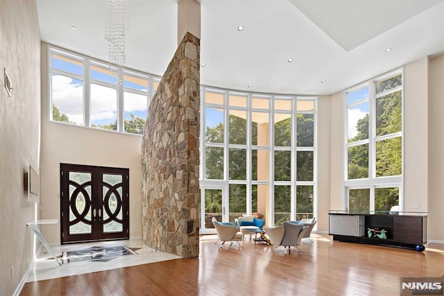 foyer featuring a chandelier, light hardwood / wood-style floors, and a high ceiling