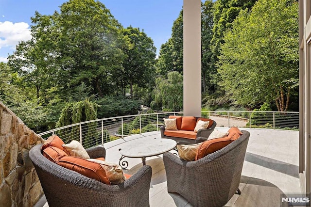 view of patio with outdoor lounge area and a balcony