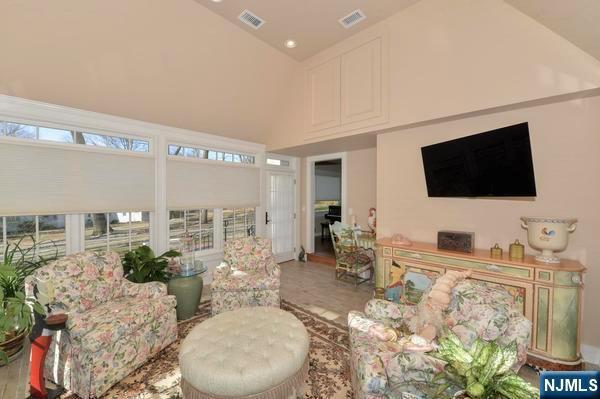 living room with high vaulted ceiling