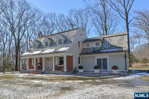 cape cod house with a porch