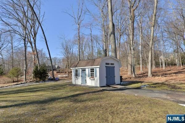 view of outbuilding featuring a lawn