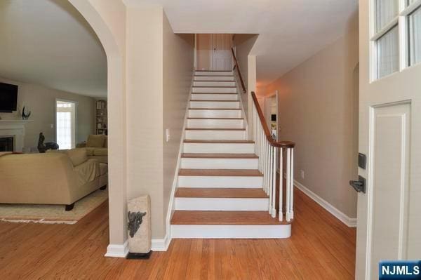 stairway with hardwood / wood-style flooring