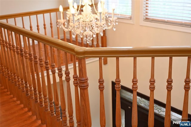 stairway with an inviting chandelier