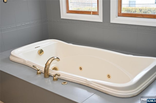 bathroom featuring a relaxing tiled tub