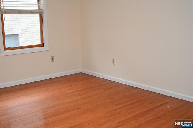 unfurnished room with wood-type flooring