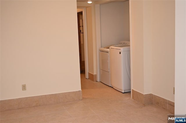 laundry area featuring light tile patterned floors and independent washer and dryer