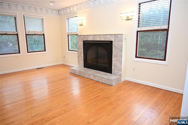 unfurnished living room with a fireplace and light hardwood / wood-style flooring