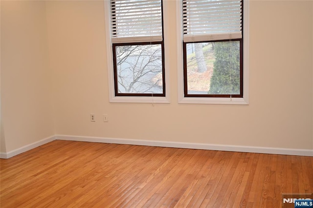 empty room with light hardwood / wood-style floors