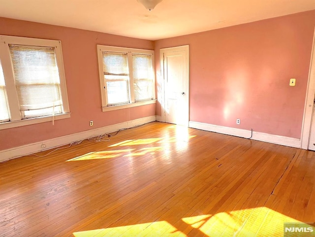 unfurnished room with light hardwood / wood-style flooring