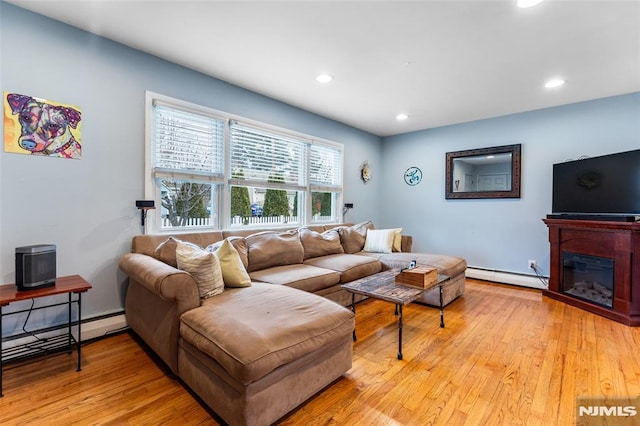 living room featuring light hardwood / wood-style floors and a baseboard radiator