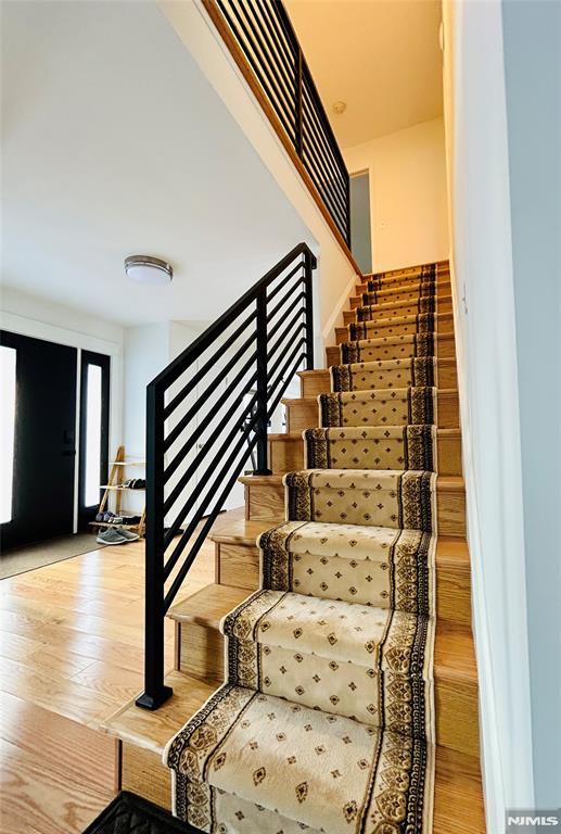 stairs featuring hardwood / wood-style flooring