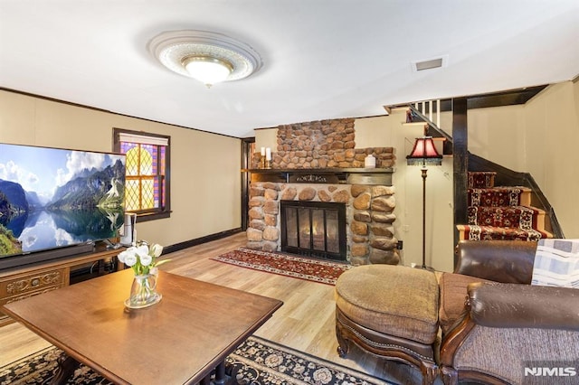 living room featuring a fireplace and light wood-type flooring