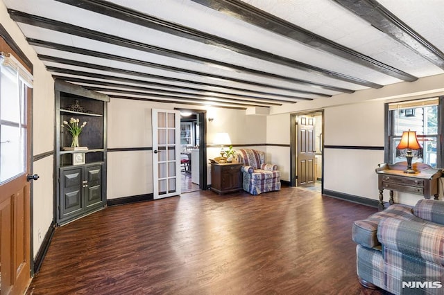 living room featuring dark hardwood / wood-style flooring, beam ceiling, and french doors