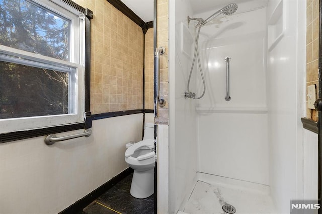 bathroom featuring toilet and walk in shower