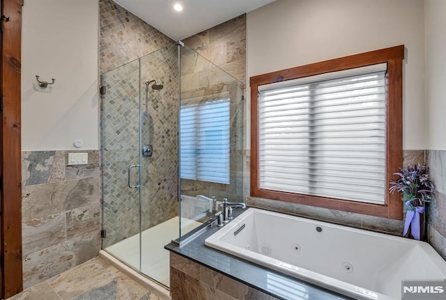 bathroom featuring shower with separate bathtub