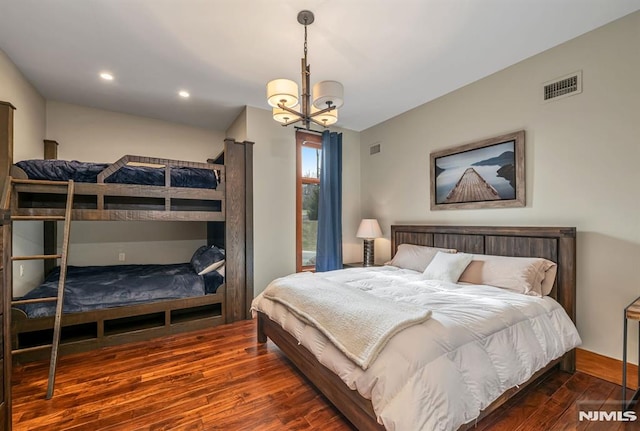 bedroom featuring dark hardwood / wood-style flooring and a chandelier