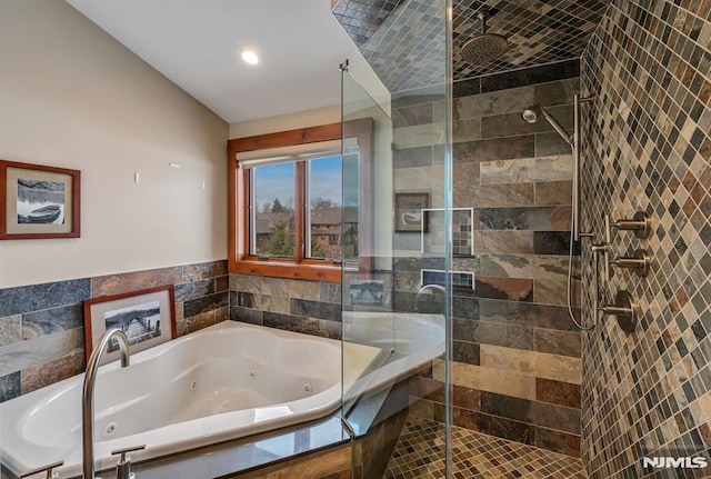 bathroom featuring lofted ceiling and independent shower and bath