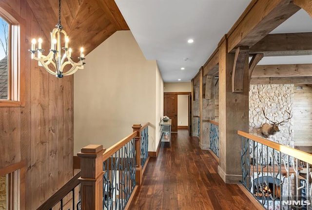 hallway with a notable chandelier and dark hardwood / wood-style floors