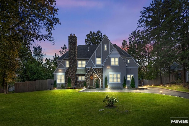 back house at dusk with a yard