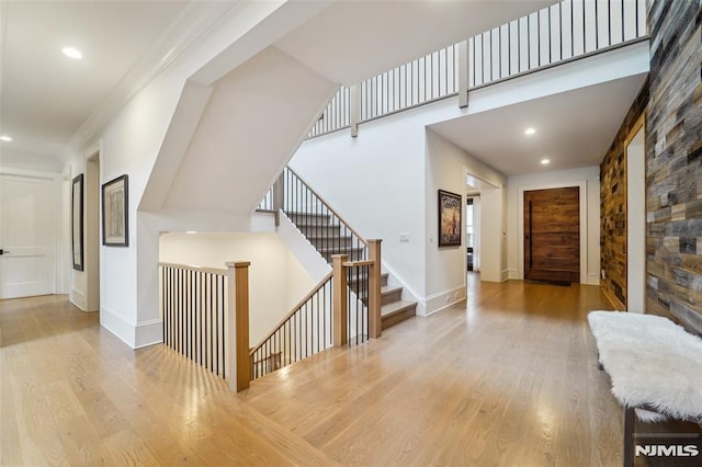 entrance foyer with light wood-type flooring and ornamental molding