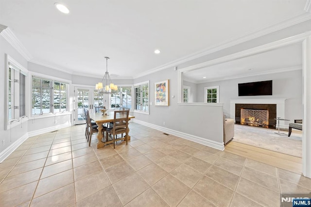 dining space with ornamental molding, light tile patterned floors, and a notable chandelier