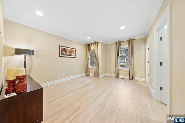 interior space featuring crown molding and light hardwood / wood-style floors