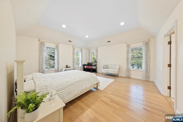 bedroom featuring vaulted ceiling and light wood-type flooring