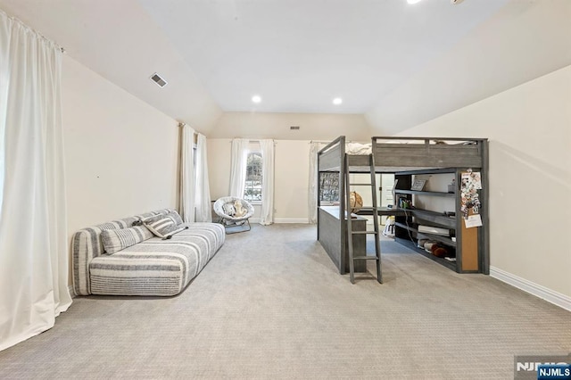 bedroom with lofted ceiling and light carpet