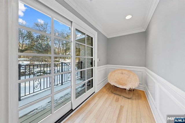 interior space featuring ornamental molding and light hardwood / wood-style floors