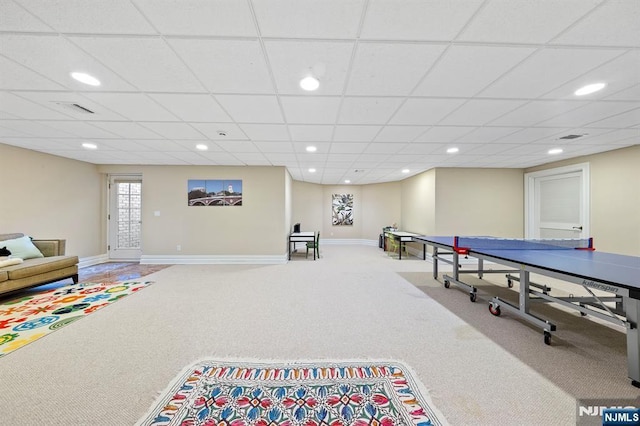 playroom with a paneled ceiling and carpet flooring