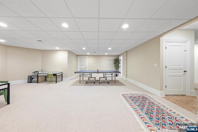 recreation room with a paneled ceiling and carpet flooring