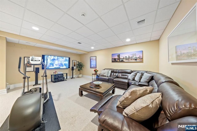 carpeted living room featuring a paneled ceiling