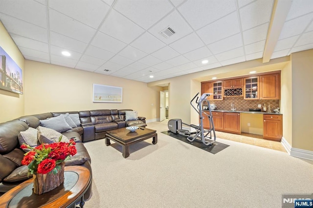 carpeted living room with wet bar