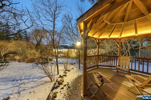 snow covered deck featuring a gazebo