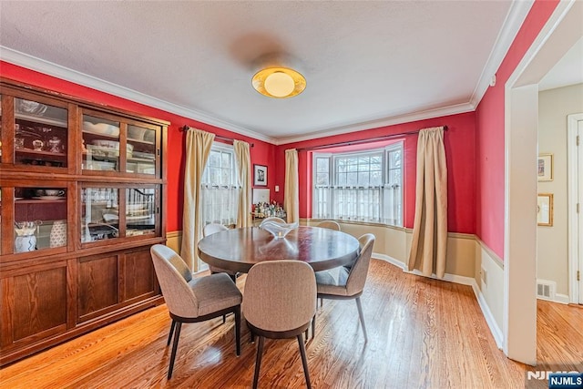 dining area featuring ornamental molding and hardwood / wood-style floors