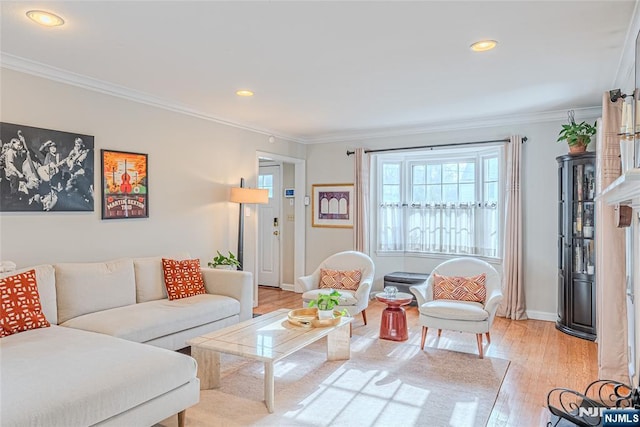 living room with light hardwood / wood-style flooring and ornamental molding