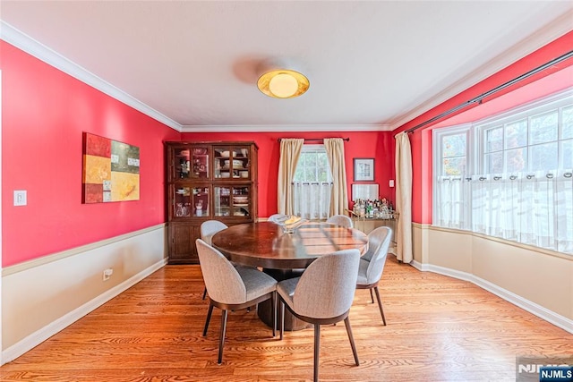 dining area featuring crown molding and hardwood / wood-style floors