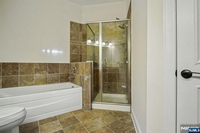 bathroom featuring separate shower and tub and toilet