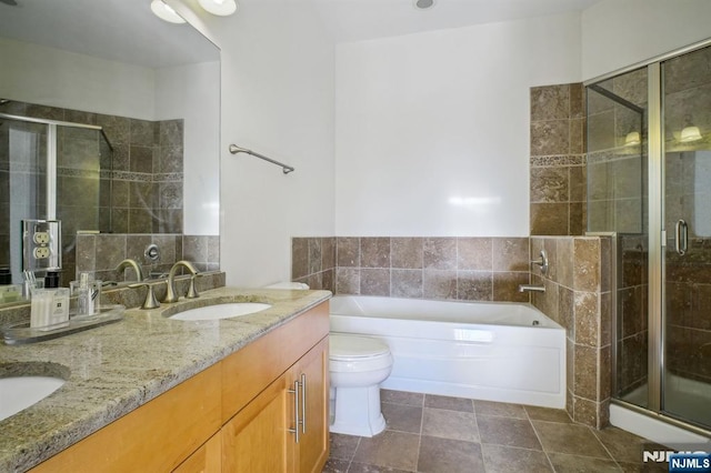 full bathroom featuring vanity, shower with separate bathtub, and toilet