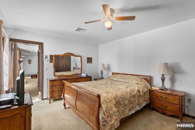 bedroom with ceiling fan and light carpet