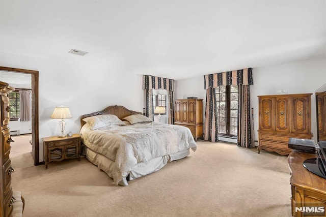 carpeted bedroom featuring baseboard heating