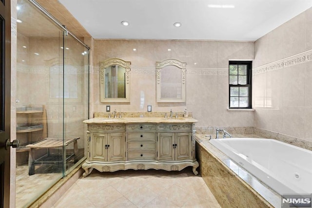 bathroom featuring vanity, tile patterned floors, tile walls, and separate shower and tub