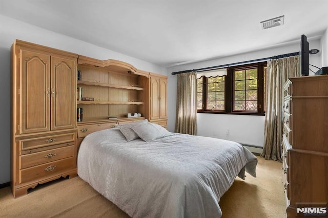 carpeted bedroom with a baseboard radiator