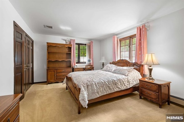 carpeted bedroom with a baseboard radiator