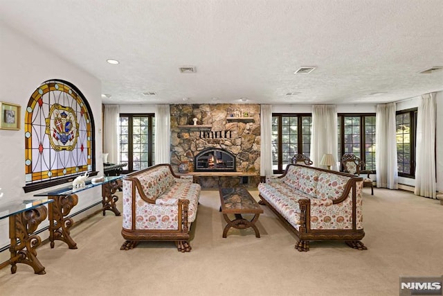 carpeted living room with a fireplace and a textured ceiling