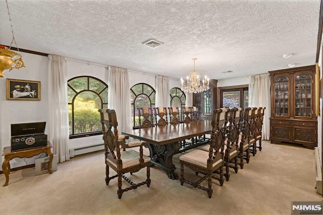 dining room featuring a textured ceiling, a baseboard heating unit, light carpet, and an inviting chandelier