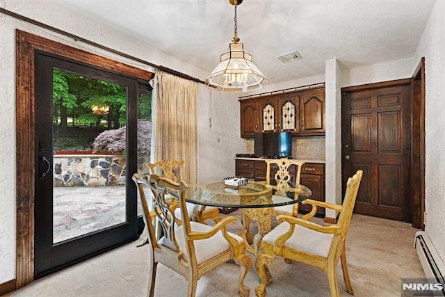 dining space featuring a baseboard heating unit