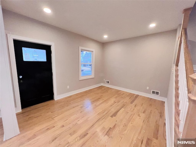 foyer entrance with light hardwood / wood-style floors